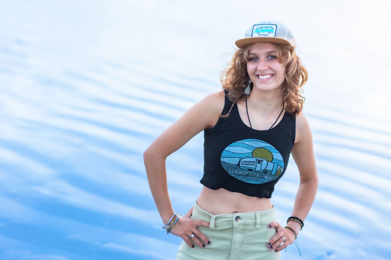 Senior portrait of a young woman in a cap standing in shallow water
